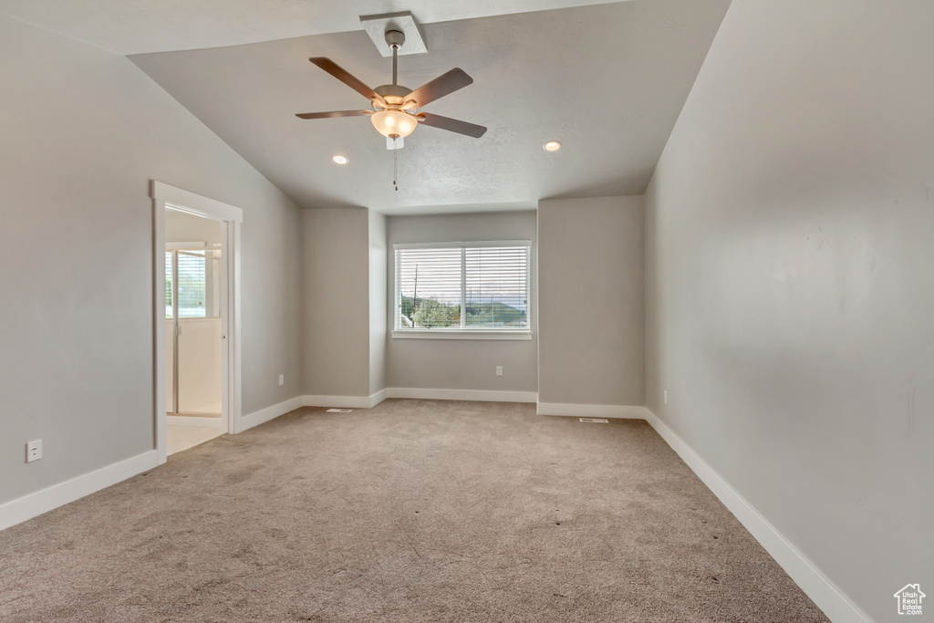 Unfurnished room featuring baseboards, light carpet, a ceiling fan, and plenty of natural light