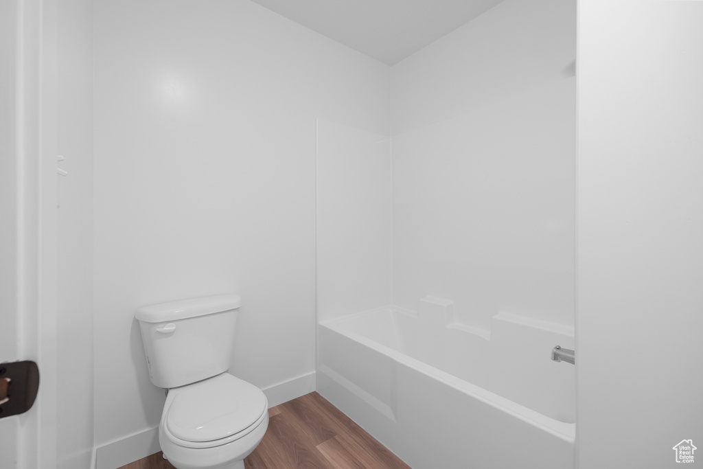 Bathroom featuring wood finished floors and toilet