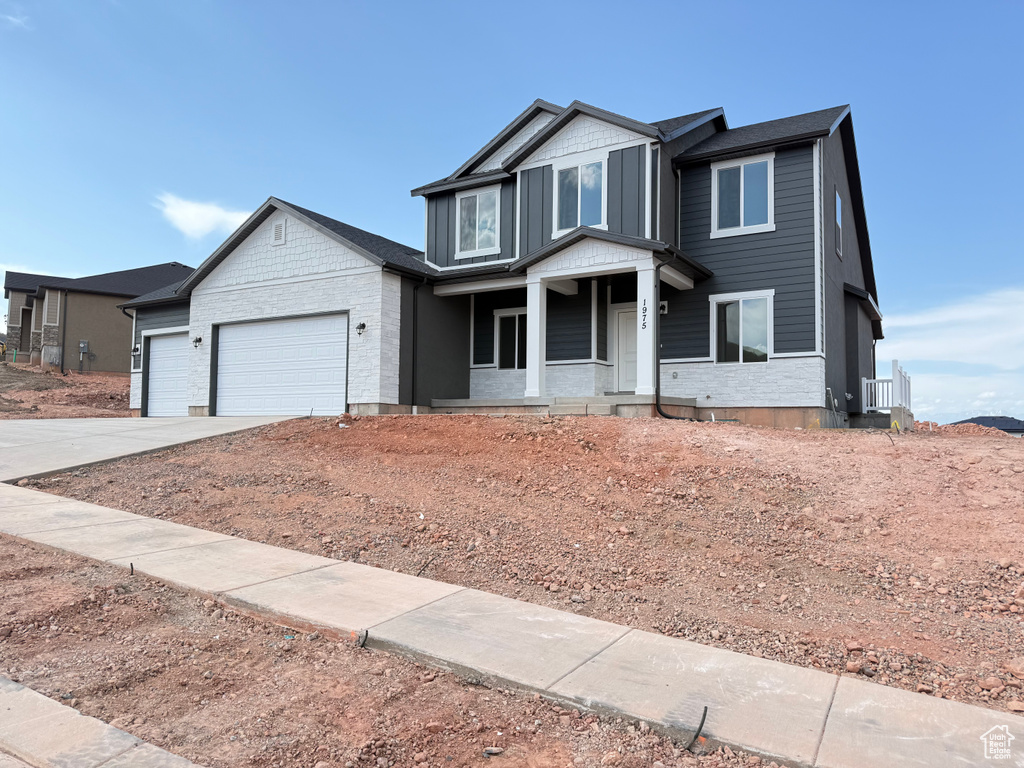 Craftsman house featuring driveway, a garage, and a porch