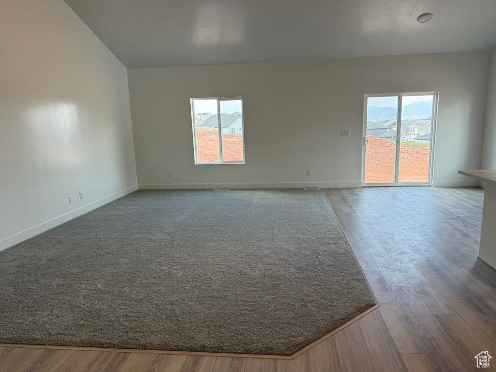 Spare room featuring wood finished floors and baseboards