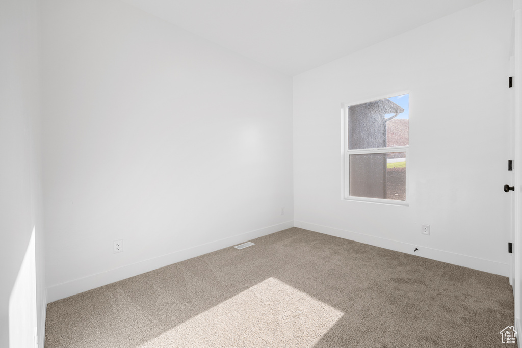 Unfurnished room with carpet floors