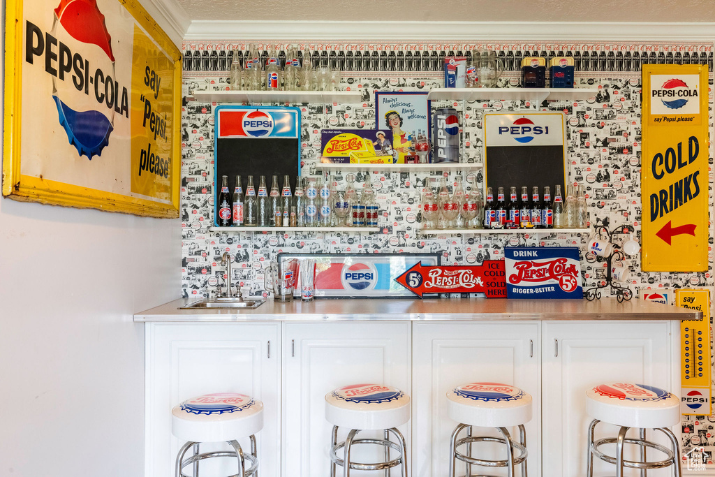 Indoor dry bar featuring crown molding