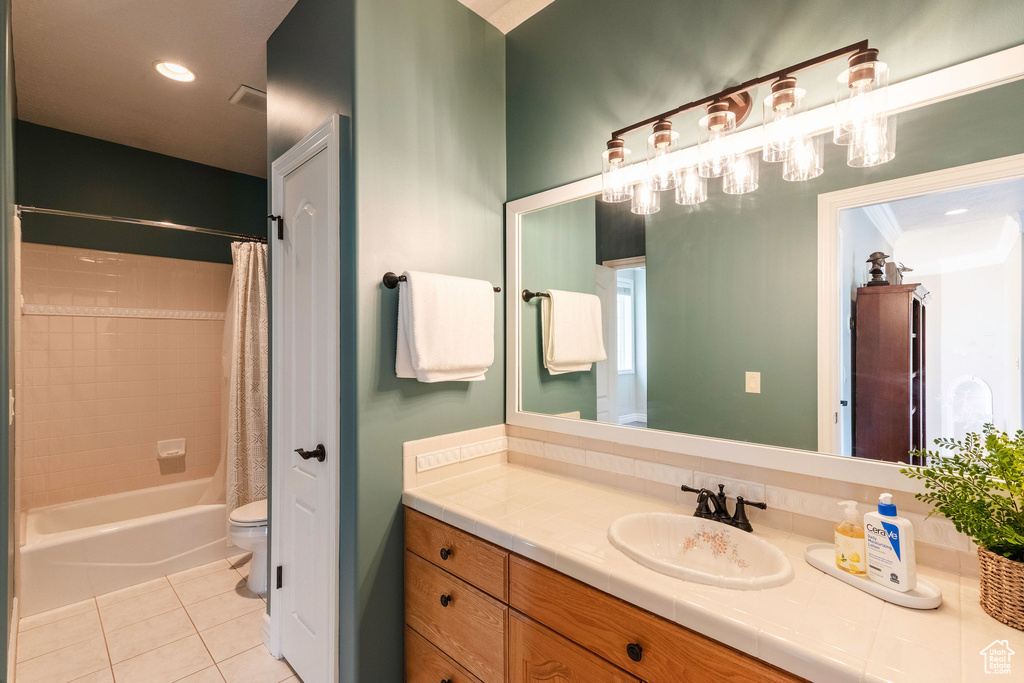 Bathroom with tile patterned flooring, vanity, shower / tub combo, and a chandelier