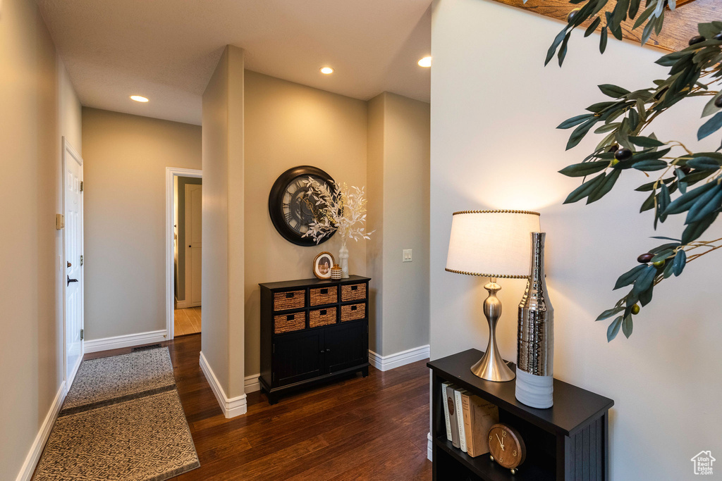 Corridor featuring wood finished floors and recessed lighting