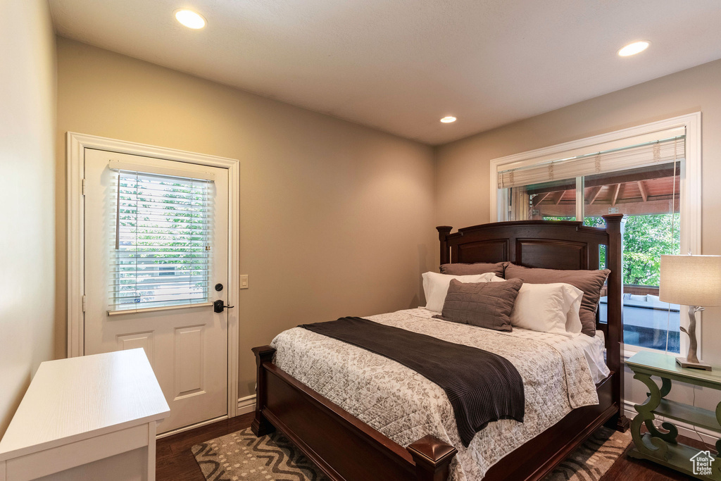 Bedroom featuring multiple windows, dark wood-style floors, and recessed lighting