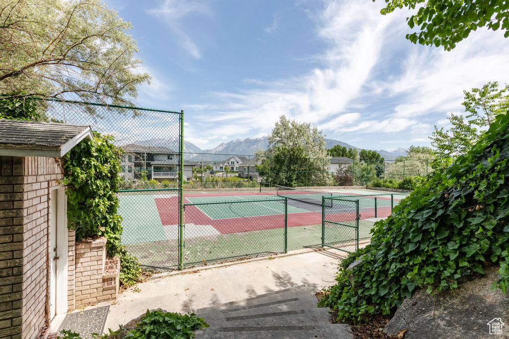 View of tennis court featuring a mountain view