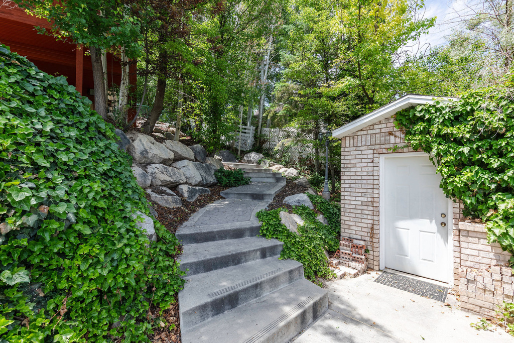 View of yard with stairs and an outdoor structure
