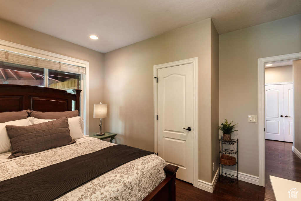 Bedroom with dark wood-style flooring and recessed lighting