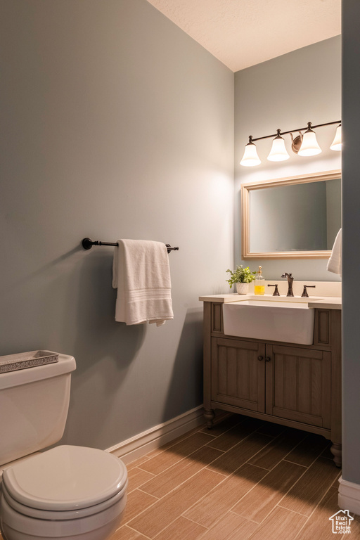 Bathroom featuring vanity and wood tiled floors