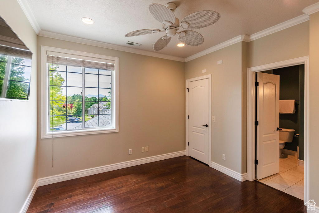 Unfurnished bedroom featuring multiple windows, wood finished floors, crown molding, recessed lighting, and ceiling fan
