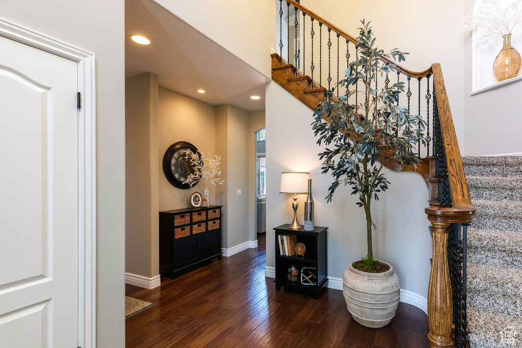 Stairway featuring wood finished floors and recessed lighting