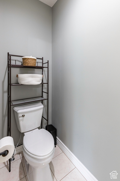 Bathroom with toilet and tile patterned flooring