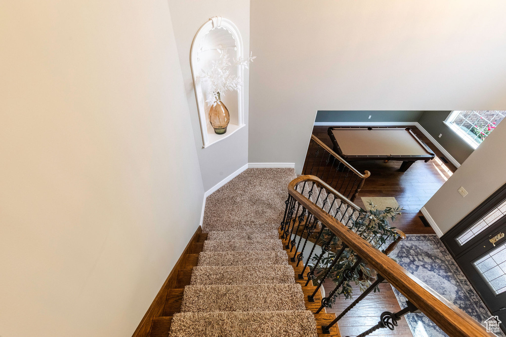 Stairs with baseboards and wood finished floors