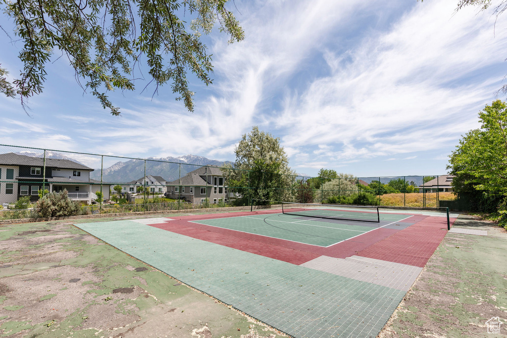 View of tennis court with community basketball court, a residential view, and a mountain view