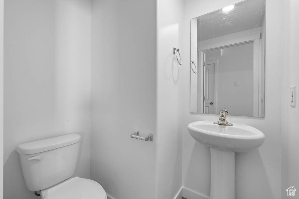 Half bathroom featuring toilet and a sink