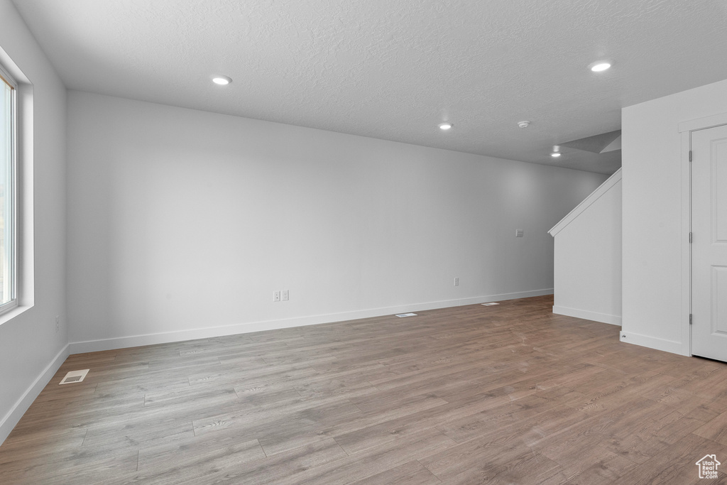 Interior space with baseboards, recessed lighting, visible vents, and light wood-style flooring