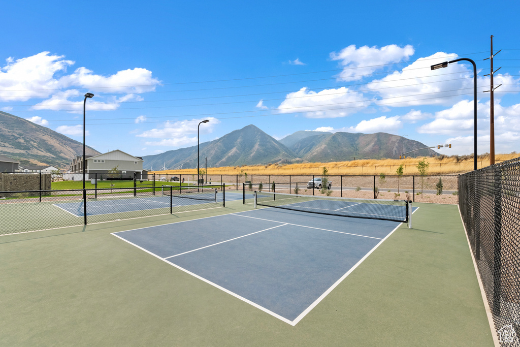 View of sport court with a mountain view and fence