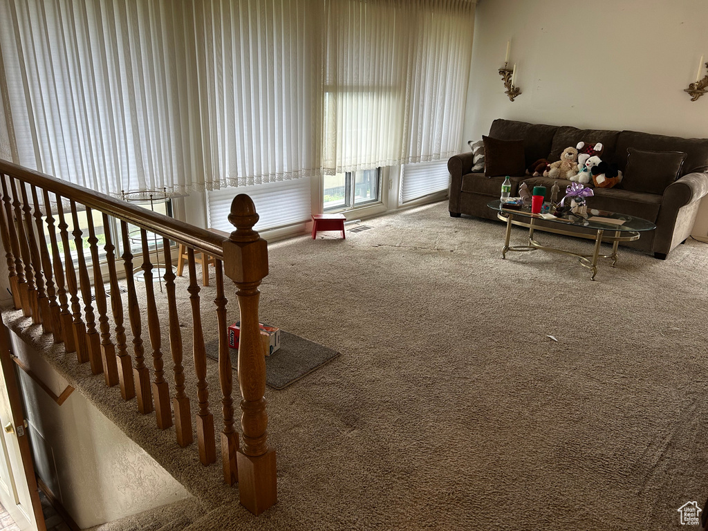 Living area featuring carpet and visible vents