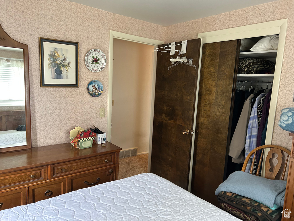 Bedroom featuring visible vents, a closet, and carpet flooring