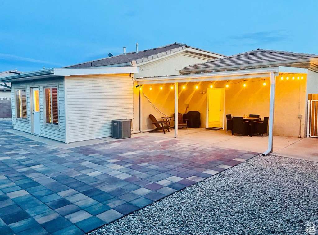 Rear view of house with a patio area and central AC unit