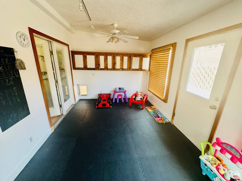 Unfurnished sunroom featuring rail lighting