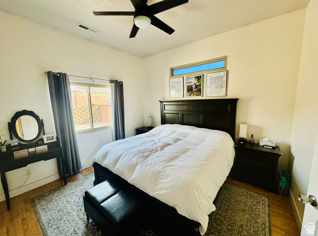 Bedroom with wood finished floors and a ceiling fan