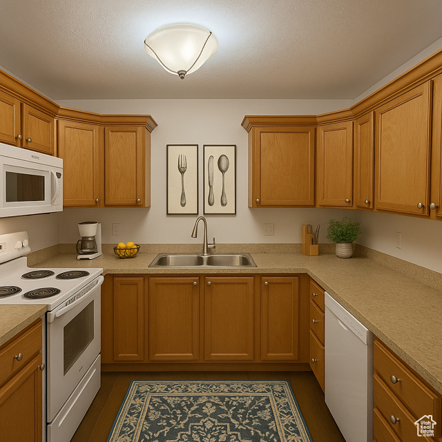 Kitchen featuring white appliances, light countertops, and brown cabinets