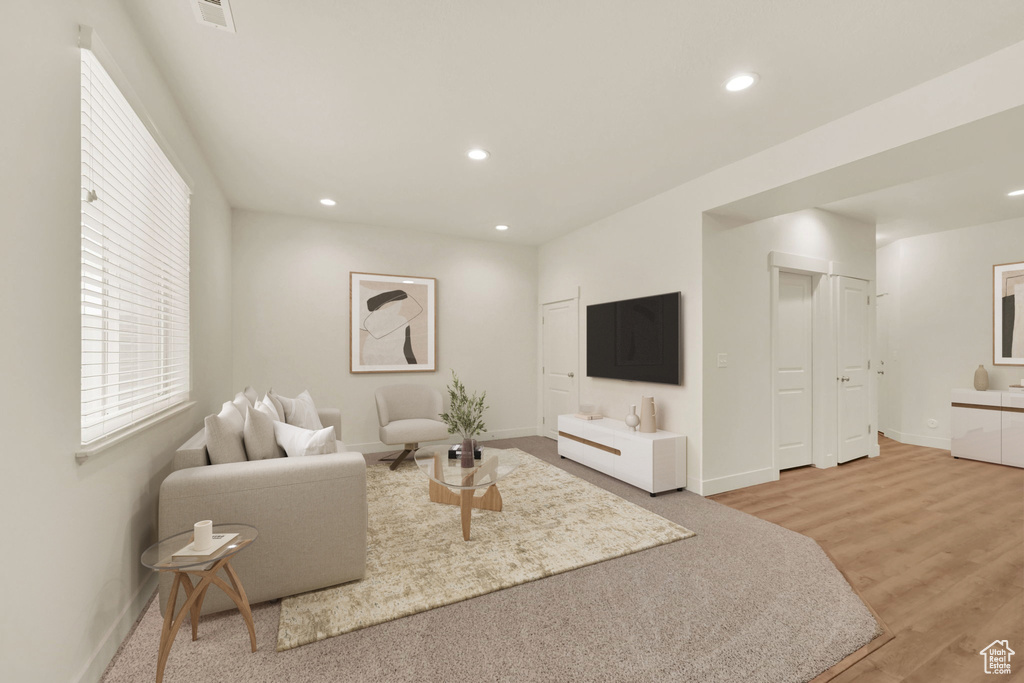 Living area featuring baseboards, recessed lighting, and light wood-style flooring