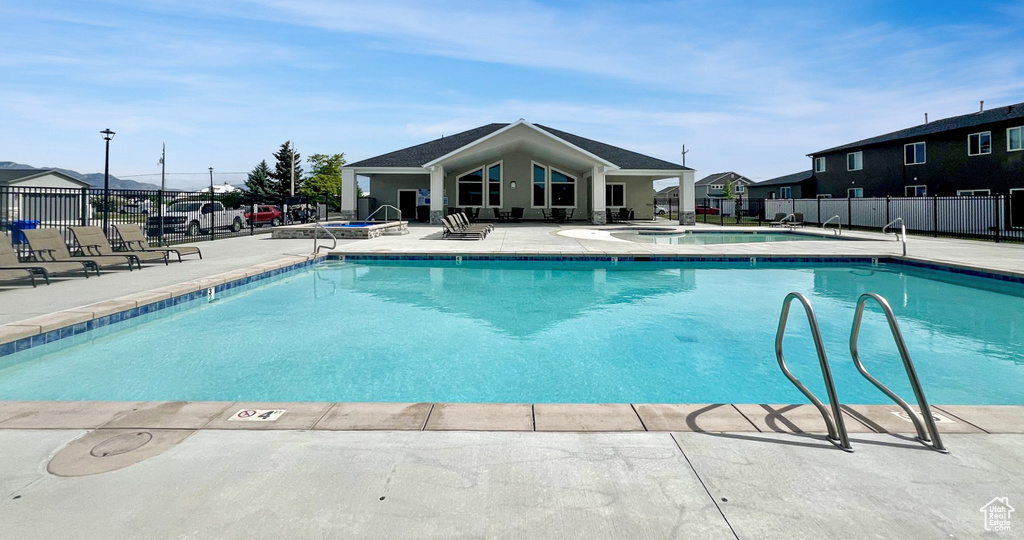 Community pool featuring a patio