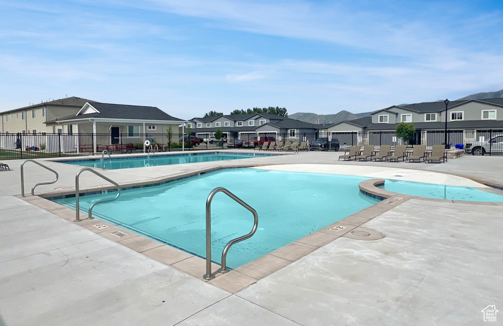 Community pool with a residential view and a patio area