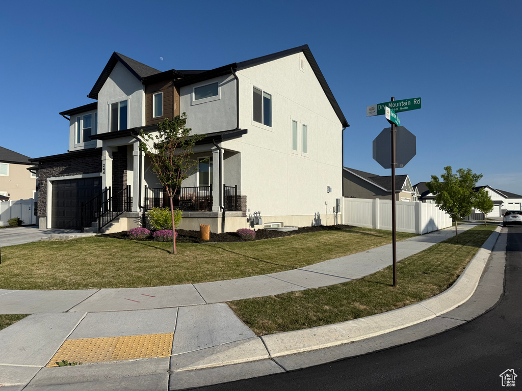 View of front facade featuring a garage and stucco siding