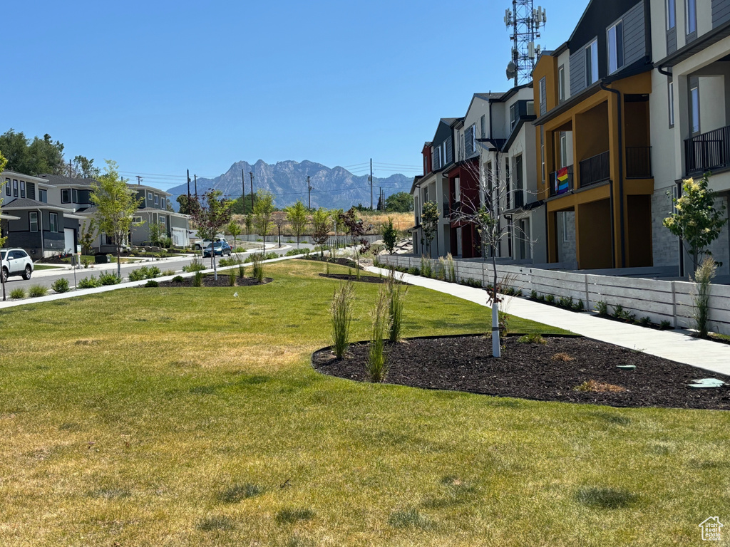 View of property's community with a mountain view, a residential view, and a lawn