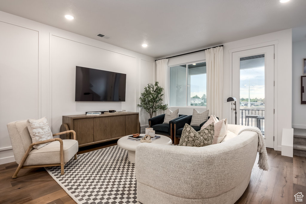 Living room featuring dark wood-type flooring and recessed lighting