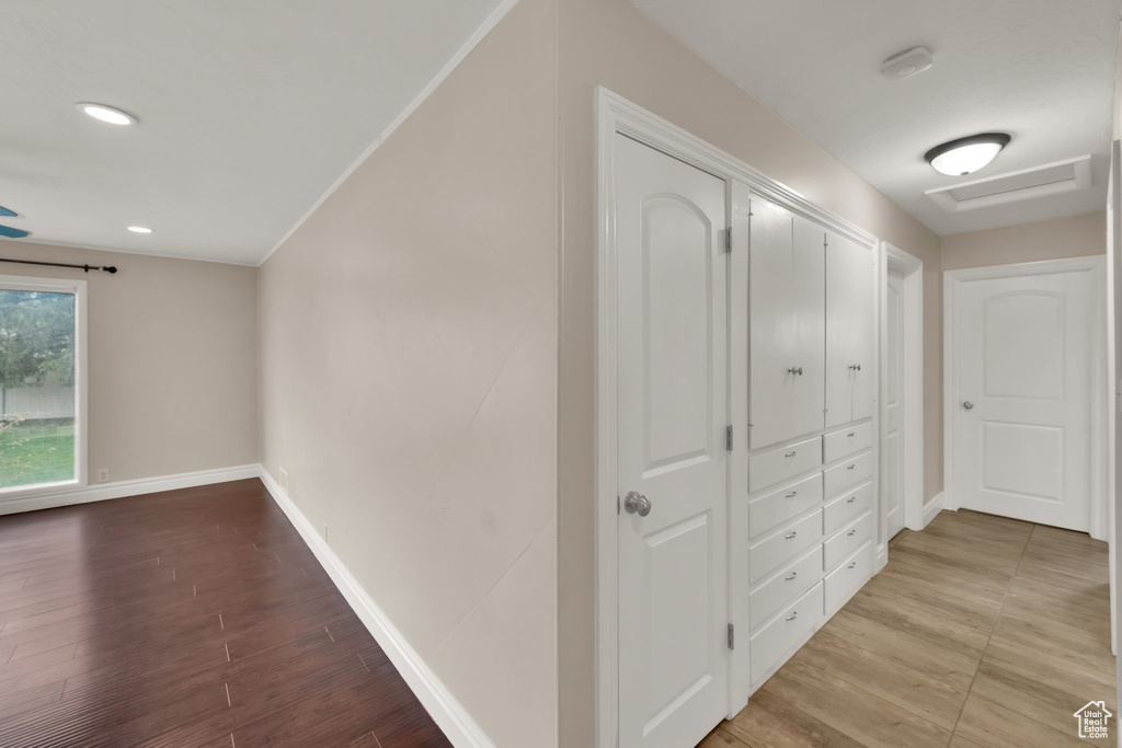 Corridor with recessed lighting, light wood-type flooring, and baseboards