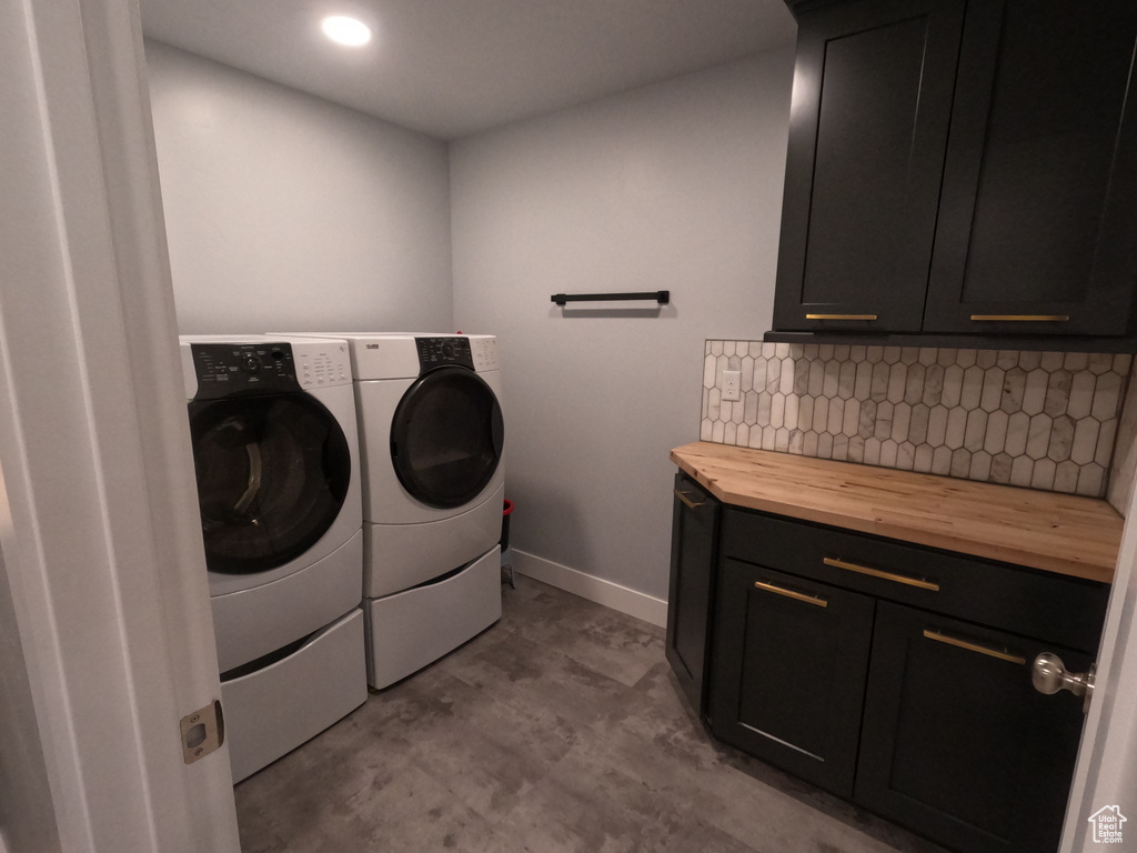 Laundry area with cabinet space, independent washer and dryer, and recessed lighting