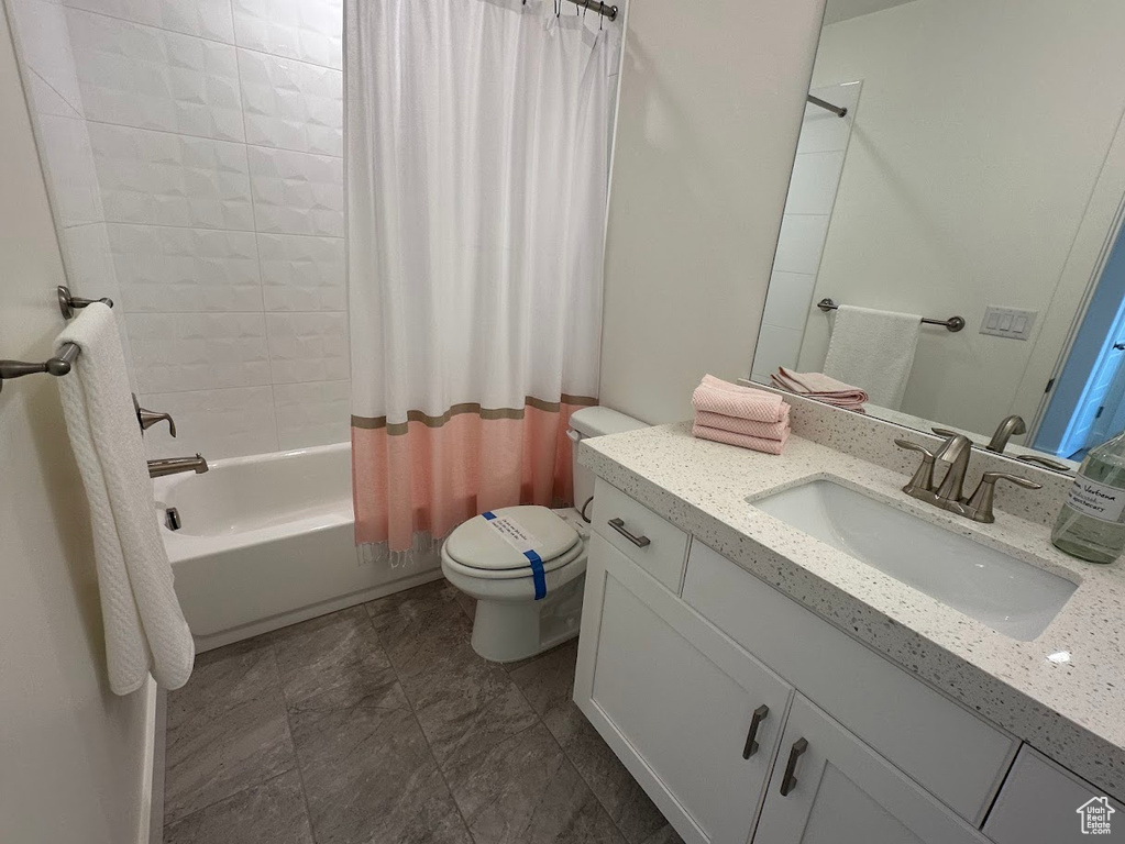 Full bathroom featuring shower / bath combination with curtain, vanity, and toilet