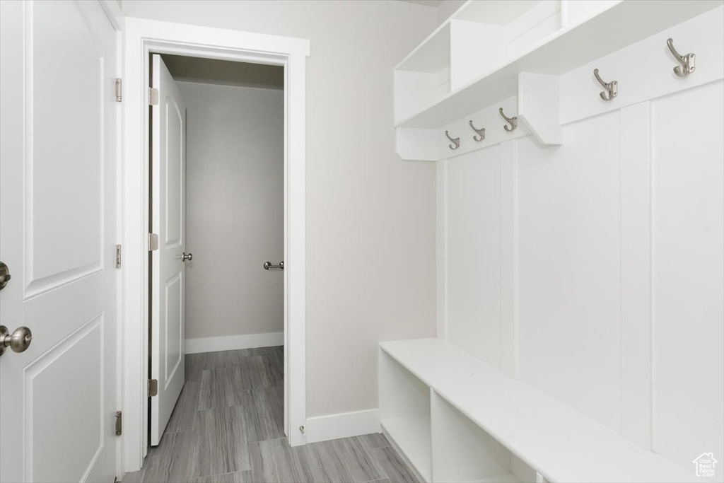 Mudroom with baseboards and light wood finished floors