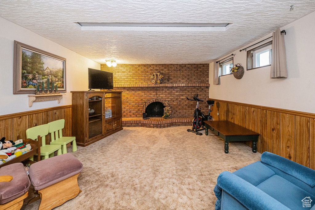 Living area with wooden walls, wainscoting, and a textured ceiling