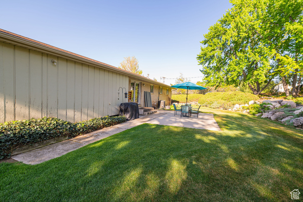 View of yard with a patio