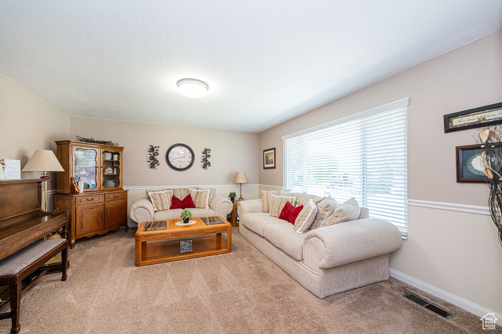 Living room featuring visible vents and carpet flooring