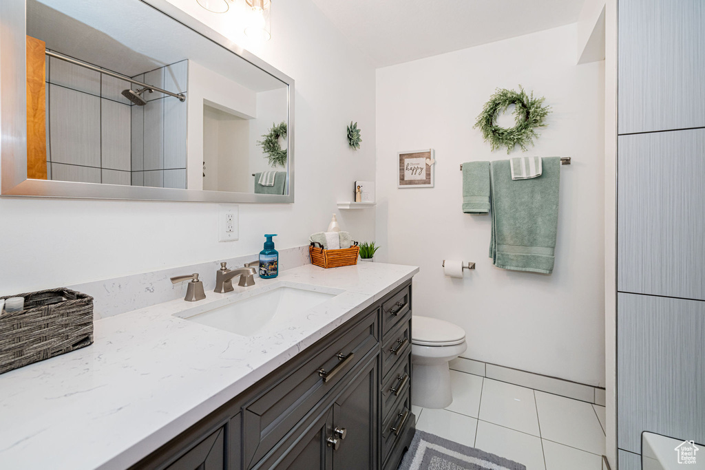 Bathroom featuring vanity, toilet, and tile patterned floors