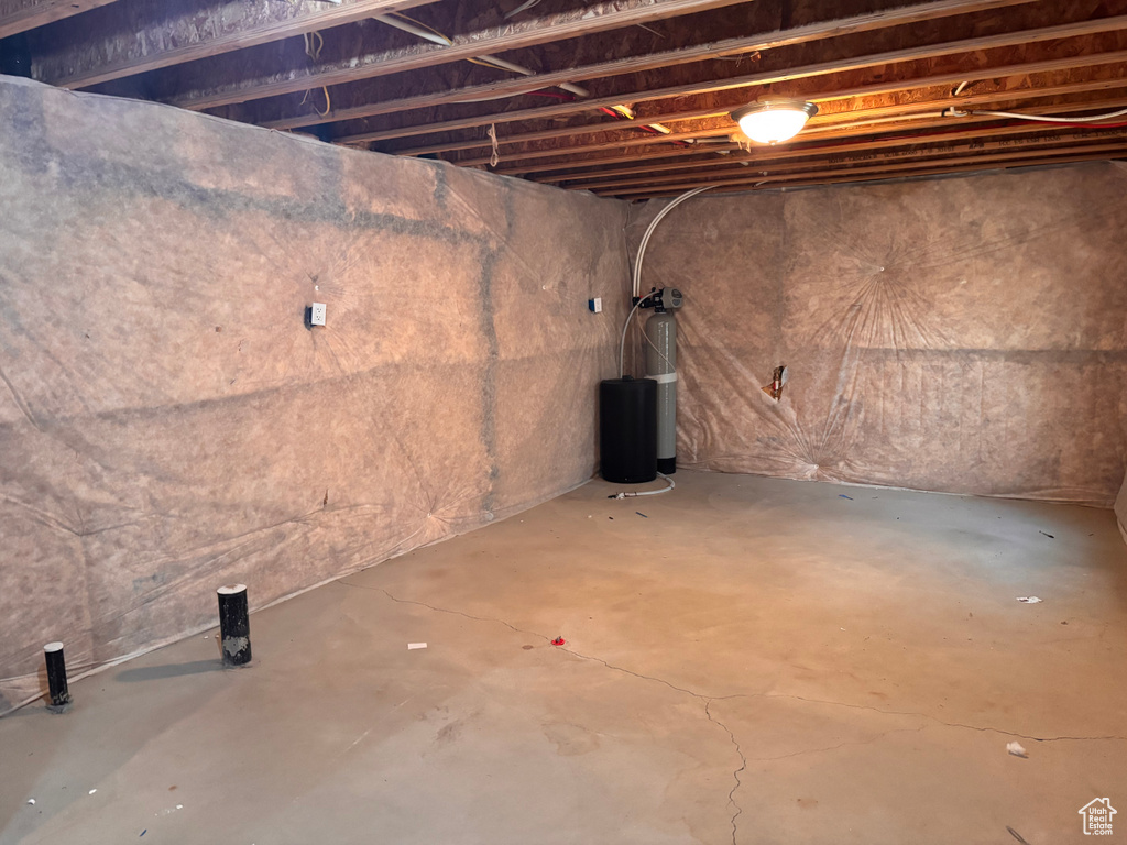 Unfinished below grade area featuring a water softener system