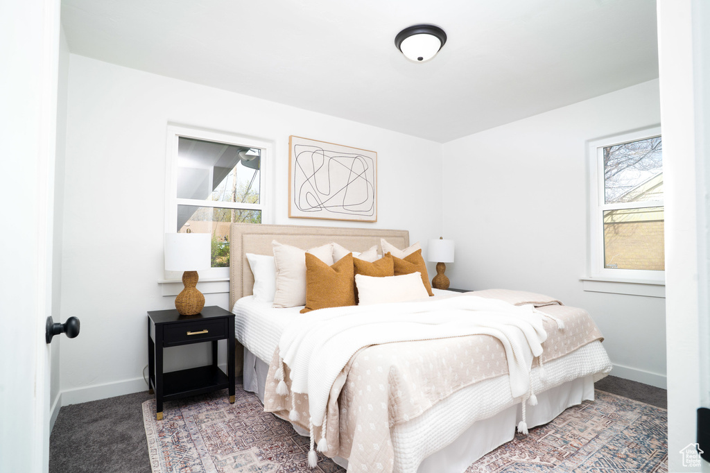 Carpeted bedroom with baseboards
