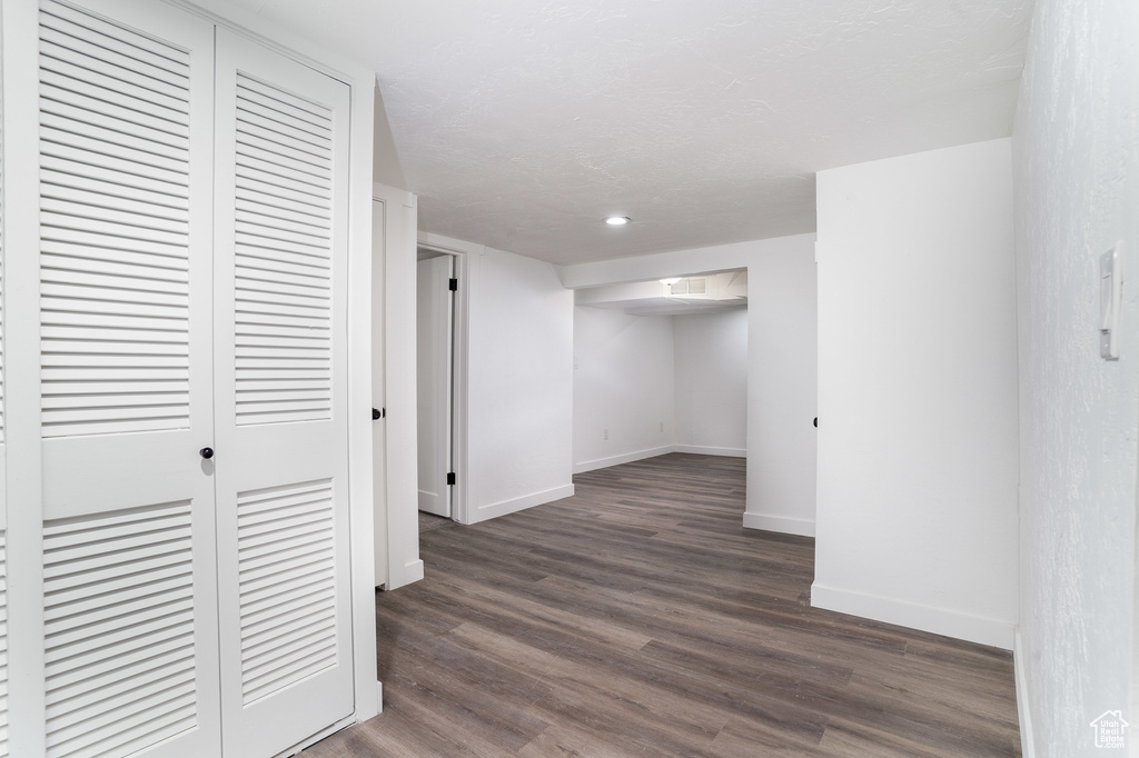 Finished below grade area with baseboards, recessed lighting, and dark wood-style floors