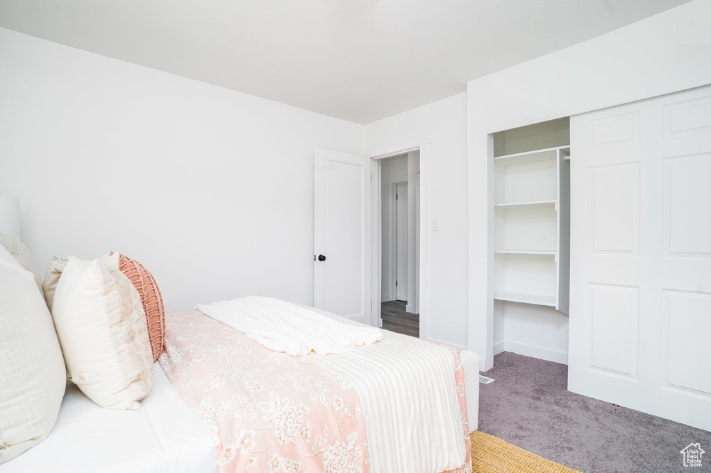 Carpeted bedroom with a closet