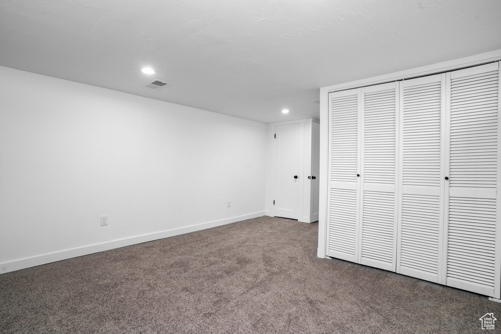 Unfurnished bedroom with a closet, carpet, baseboards, visible vents, and recessed lighting