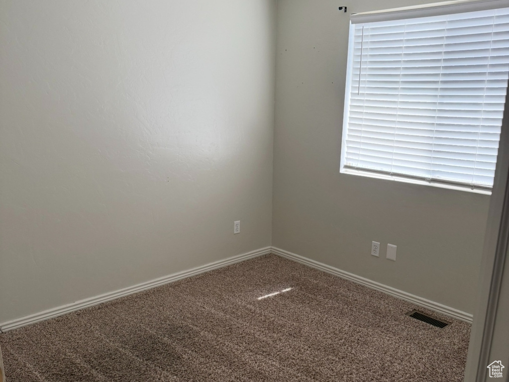Unfurnished room featuring carpet flooring and baseboards