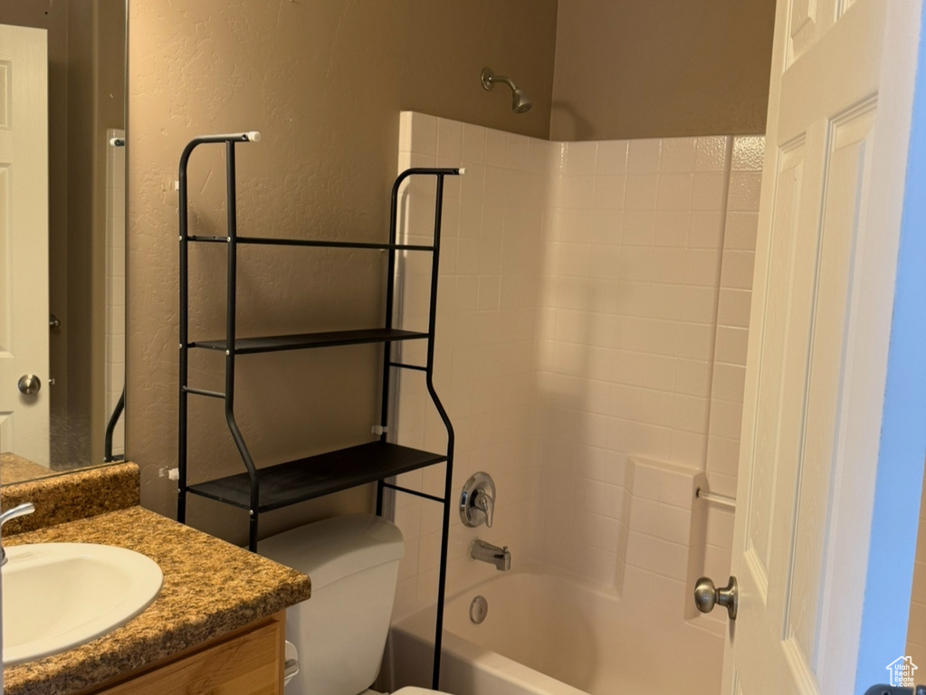 Full bathroom with toilet, vanity, tile patterned flooring, and  shower combination