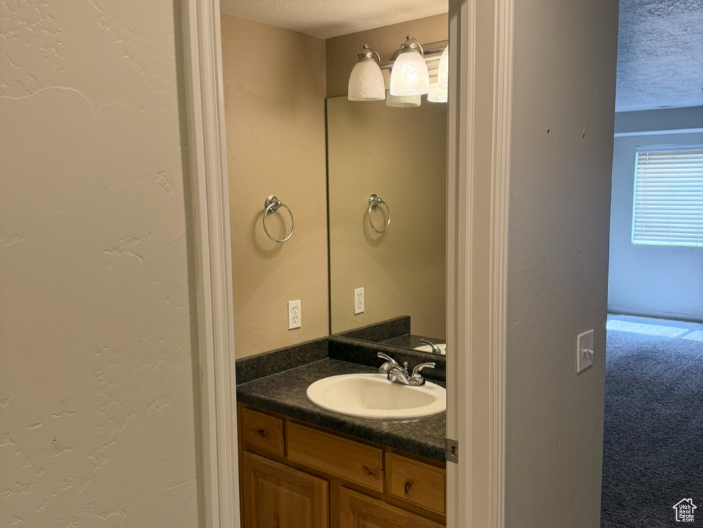 Bathroom featuring tile patterned flooring and vanity