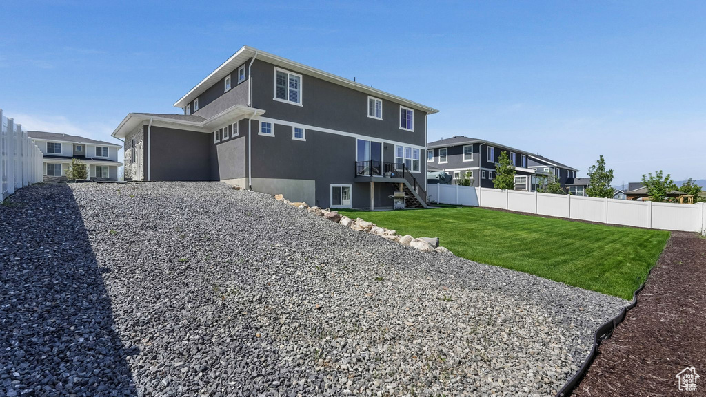 Back of house with stairway, stucco siding, and a residential view